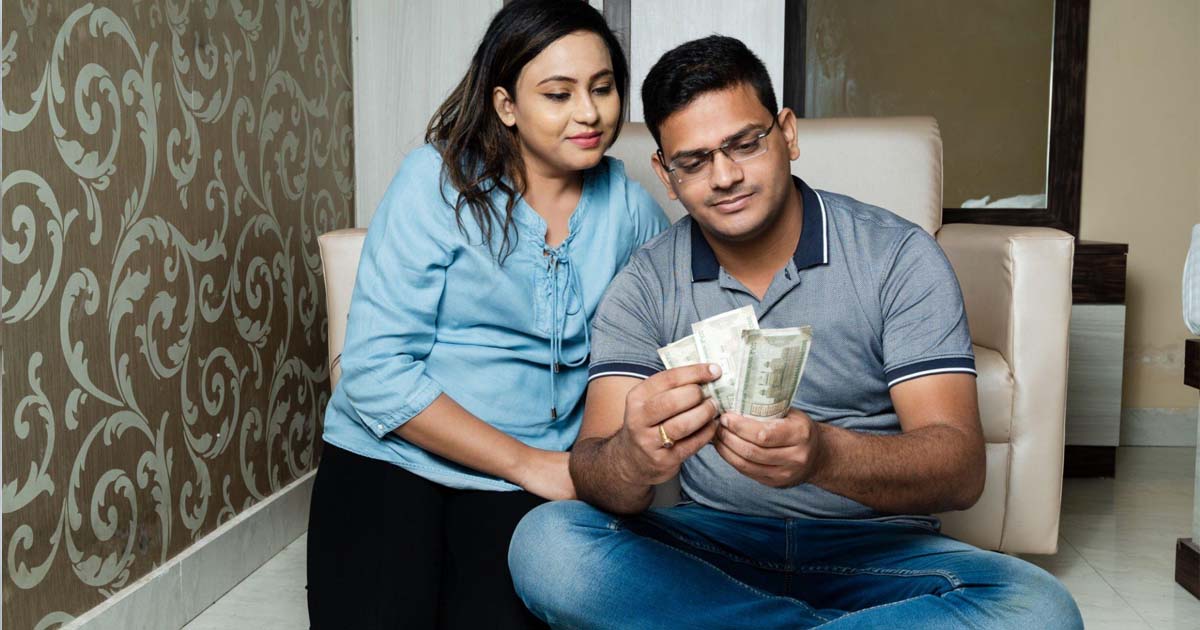 Indian couple holding currency