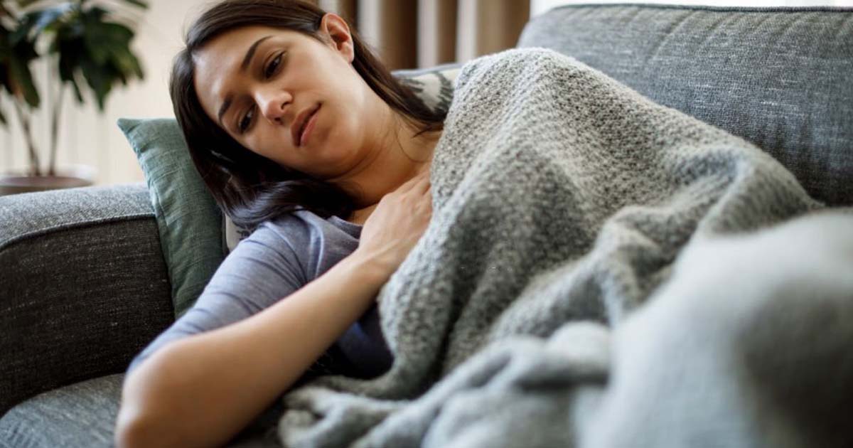 Sick woman lying in bed