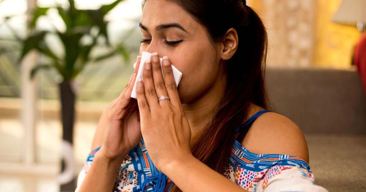 woman blowing her nose