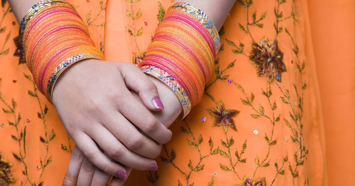 Close up of bangles on a woman's wrists