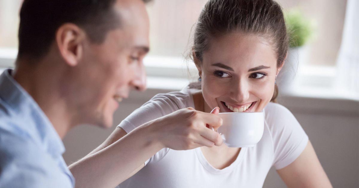 Smiling woman drinking coffee