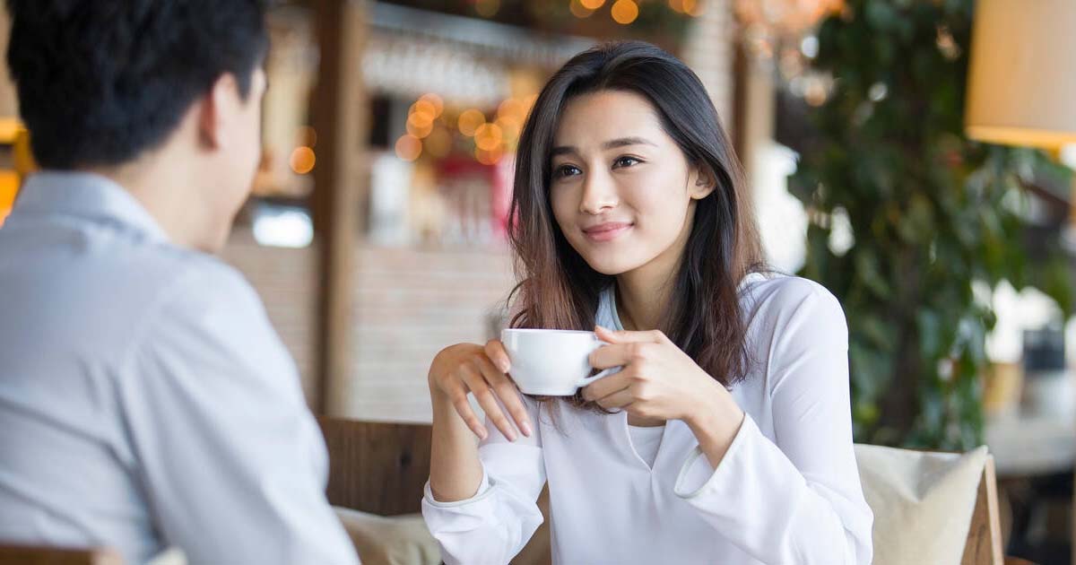 Young woman and man talking in cafe