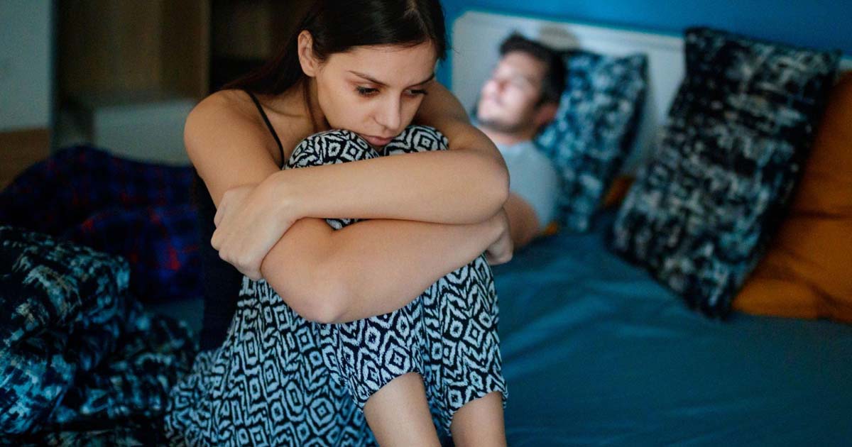 woman sitting on bed